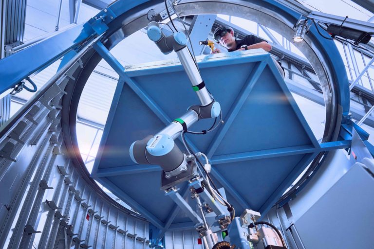 Scientist researches together with robot arm